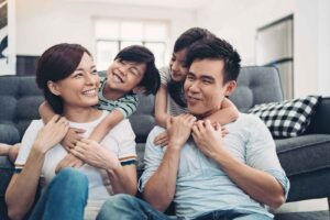 Family hanging out indoors on couch